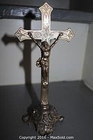 Full view of the silver altar crucifix standing on its ornate pedestal base, showing the complete item and relative size.