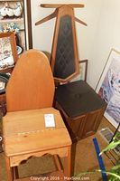 Wide shot showing both multifunction wooden chairs; left is the step stool/ironing board/chair, right is the gentleman's chair with black cushioned seat and backrest with diamond pattern.