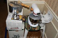 Group shot showing white KitchenAid mixer on stand with attached bowl, Whirley Pop pan on original box and recipe booklet.
