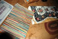 Photo showing three rugs including the striped rug, floral rug, and 'Grandchildren Spoiled Here!' rug partially visible