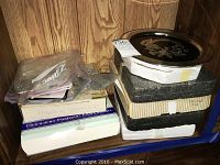 Stack of boxes containing collectible decorative plates in original packaging including Kaiser and others