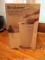 Front view of original box showing towel warmer image and branding