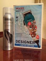 Wahl Total Clipper Care aerosol can next to the product box showing limited edition designer clipper with koi fish and lily design.
