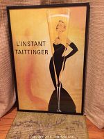 Front of the framed champagne advertisement poster showing Grace Kelly and the text 'L'INSTANT TAITTINGER'