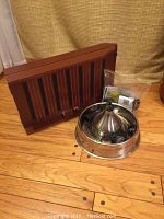 Photo of wood dog ramp with vertical black anti-slip strips and stainless steel Drinkwell pet fountain with accessories and replacement filters