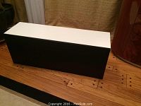 White base cabinet with black door, rectangular shape, modern minimalist design.