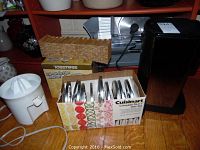 Overview of all items: Waring FS150 slicer, Cuisinart coffee maker, Toastess toaster with box, box of Cuisinart DLC-7 discs, orange juicer missing lid.