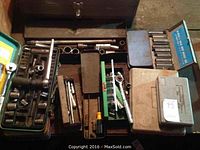 Multiple socket sets in plastic and metal cases along with ratchets and socket wrench accessories.