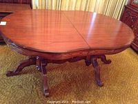 Full assembled table showing overall shape, finish and pedestal bases