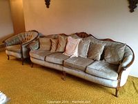 Wide shot showing both sofa and matching armchair side by side on carpet