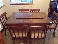 Full set overview showing rectangular table with leaf and six matching chairs
