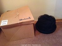Photo of the boxed hat showing the Woodward's box and the black vintage hat beside it.