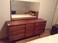 Full view of nine-drawer dresser topped with mirror