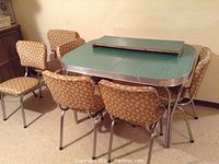 Full view of retro kitchen table with six matching chairs around it.