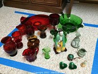Overview of various glassware, a porcelain figurine, and sterling silver candle holders