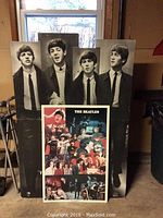 Large foldable Beatles poster board showing black and white photos of band members with smaller full color Beatles poster in front