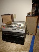 Photo showing entire stereo electronics stack with speakers and cables on carpet. A silver Technics SL-PC20 CD changer, black Teac AG-V7700 receiver, Sony PS-LX210 turntable with dust cover, two KLH speakers with wood frame and fabric grille.