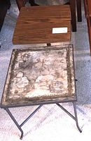 Photo showing wooden end table with rectangular top next to metal and tile topped end table on carpeted floor