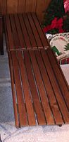 Two wood benches side by side showing slatted tops