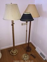 Photo showing all three floor lamps standing next to each other on a wood floor against a lavender wall.