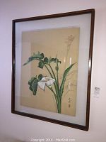 Framed Japanese lily flower painting seen from a side angle showing frame condition and artwork details.
