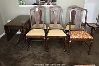 Front view of table with drop leaves down and six chairs arranged