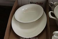 Uncovered vegetable bowl nested in large oval platter