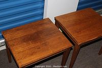 Pair of matching wood end tables viewed angled from above showing tops and legs