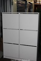 Two white IKEA shoe storage cabinets side-by-side, front view with all compartments closed.
