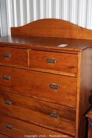 Front view of rustic pine dresser showing shaped backsplash, top surface and drawer fronts