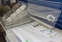 Various white metal wire shelves and accessories from Closetmaid Freedom Rail system.