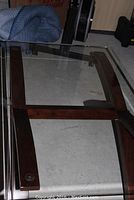 Full top view of coffee table showing rectangular glass top and wooden frame support