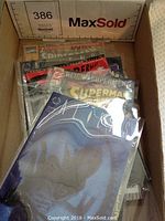 Box with multiple comic books inside plastic sleeves