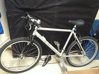 Side profile of Marin mountain bike showing silver frame with black seat and tires.