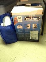 Original packaging box showing DeLonghi branding and product features.