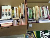 Full view of two boxes filled with cookbooks and health/diet books.