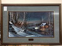 Full view of the framed winter scene artwork with a cabin, deer, and snow-covered landscape at dusk.