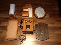 Photo of the entire lot including phone, clocks, paper towel holder, and note boards arranged on wood surface