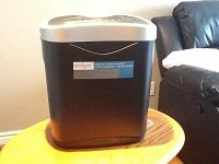Front image of Omnitech cross cut shredder sitting on a small wooden table, clearly showing size and design.