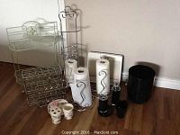 Full view of the bathroom accessory collection including metal shelves, holders, scale, toiletry sets and bin.