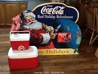 Full view of Coca-Cola foam core poster with Santa Claus, two coolers in front, and four coasters