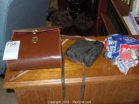 Wide shot of two binoculars sets with their carrying cases on a wooden surface.
