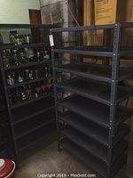 Two blue metal storage shelves placed side by side showing multiple shelf levels and overall sturdy condition.