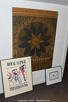 All three items arranged against a wall: large fabric wall art in the back, Royal LePage Triathlon poster and small framed bird art in front.