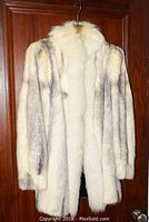 Full front view of Paul Magder fur coat highlighting black cross mink fur with white fox trim around collar and front edges.