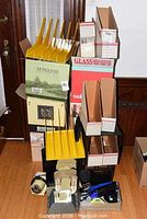 Stack of yellow plastic file organizers and cardboard magazine files along with small boxes for storage