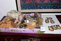 Overview of owl collection showing various owl figurines in fabric, stone, glass and pottery materials along with hanging owl mobiles