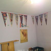Baseball pennants from multiple post-season years displayed on wall corners including Chicago Cubs and Toronto Blue Jays