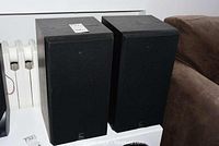 Pair of black Celestion DL6 Series Two bookshelf speakers viewed from above with grille covers on.