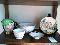 Capodimonte plate with cherubs bathing scene and gold rim, white swirled bowl, two Lenox bowls, and Royal Doulton Sairey Gamp mug